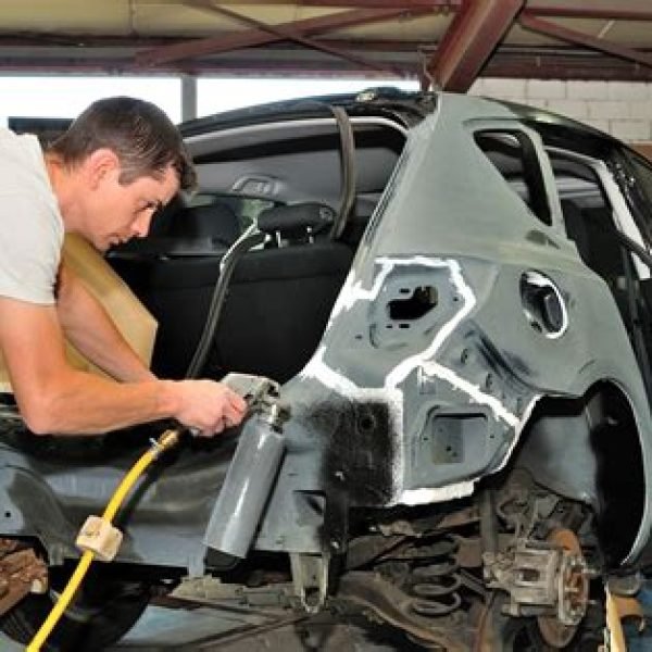 Technician working in auto body shop